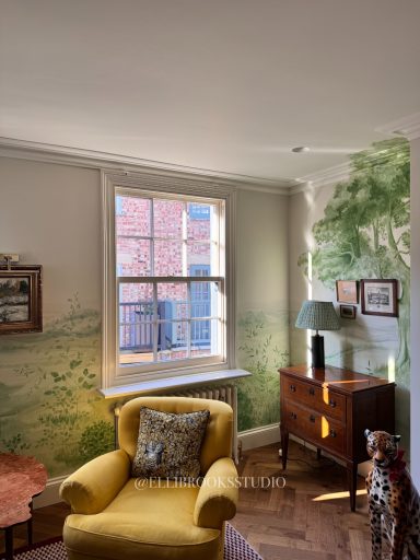 Custom scenic mural in green tones featuring rolling hills, silver birch, pine tree and botanical foreground detail.