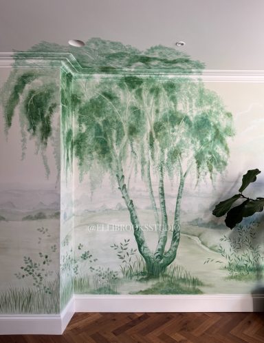 Hand-painted tonal green mural with distant hills, ceiling-height silver birch and delicate foliage.